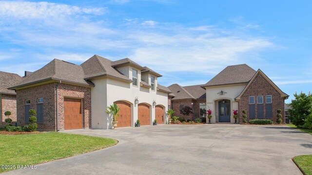 121 Snapping Ln, Broussard, LA 70518 - french country style house with driveway, roof with shingles, brick siding, a front lawn, and a garage