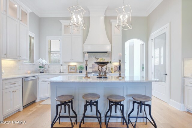 121 Snapping Ln, Broussard, LA 70518 - kitchen featuring dishwasher, a breakfast bar, white cabinets, a chandelier, and wall chimney range hood