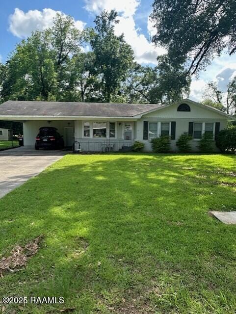 125 River Rd, Lafayette, LA 70501 - ranch-style home featuring concrete driveway, a carport, and a front lawn