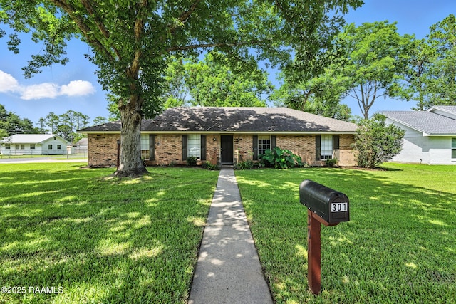 301 Estainville Ave, Lafayette, LA 70508 - ranch-style home featuring brick siding, a front yard, and a shingled roof