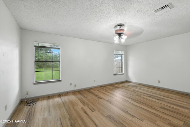 301 Estainville Ave, Lafayette, LA 70508 - empty room with wood finished floors, healthy amount of natural light, ceiling fan, and a textured ceiling