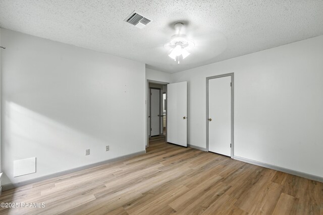 301 Estainville Ave, Lafayette, LA 70508 - unfurnished bedroom featuring light wood-type flooring, a textured ceiling, and ceiling fan