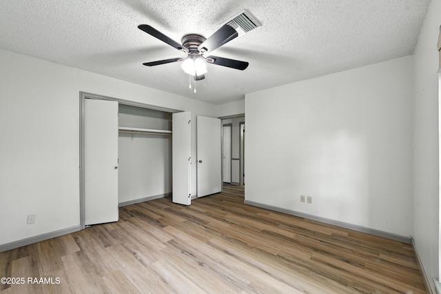 301 Estainville Ave, Lafayette, LA 70508 - unfurnished bedroom featuring wood finished floors, a closet, a ceiling fan, and a textured ceiling