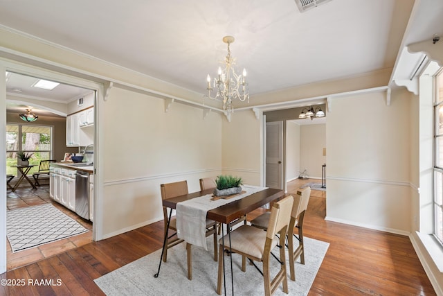 110 Shipley Dr, Lafayette, LA 70508 - dining room with a chandelier, hardwood / wood-style floors, and crown molding