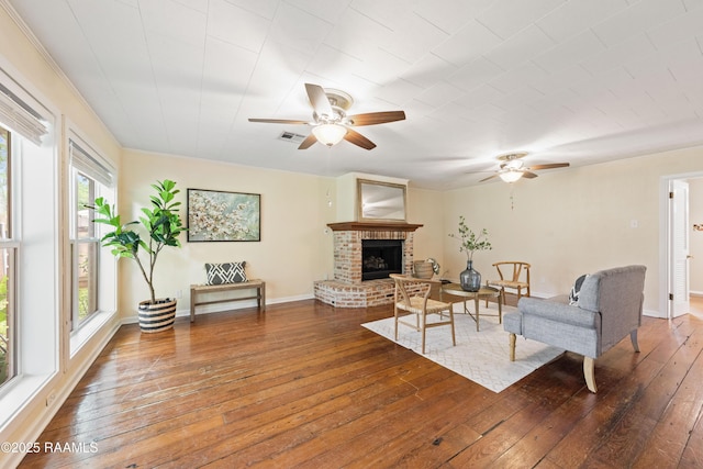 110 Shipley Dr, Lafayette, LA 70508 - living area featuring a ceiling fan, hardwood / wood-style flooring, and a fireplace