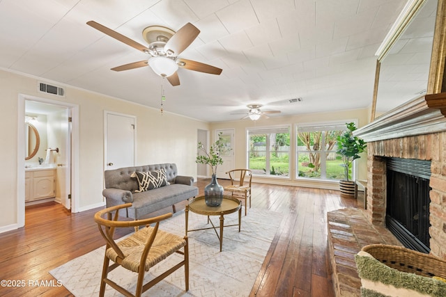 110 Shipley Dr, Lafayette, LA 70508 - living area featuring hardwood / wood-style floors, a ceiling fan, a brick fireplace, and crown molding