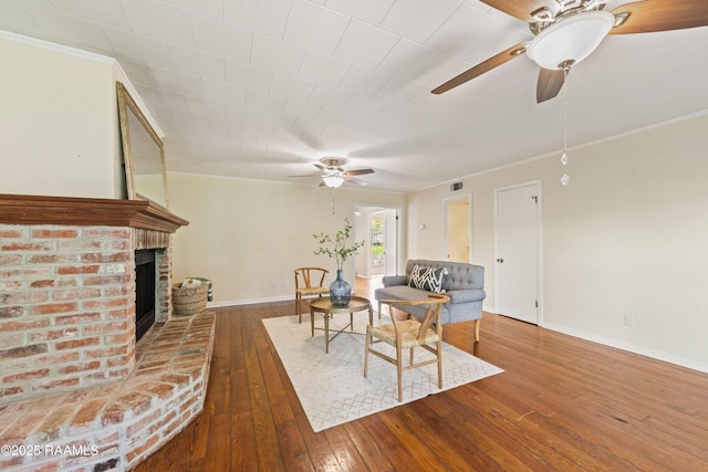 110 Shipley Dr, Lafayette, LA 70508 - living area featuring a ceiling fan, wood-type flooring, crown molding, and a fireplace