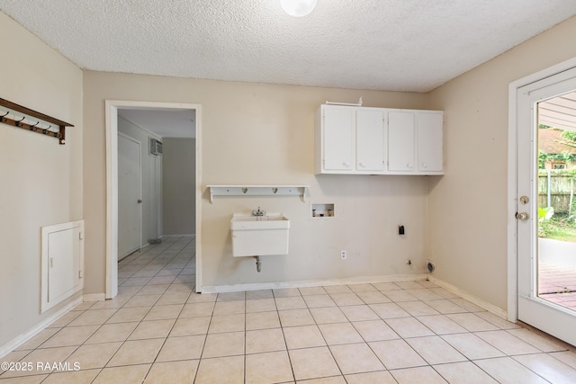 110 Shipley Dr, Lafayette, LA 70508 - laundry area with cabinet space, hookup for a washing machine, a textured ceiling, hookup for a gas dryer, and light tile patterned floors