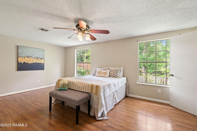 110 Shipley Dr, Lafayette, LA 70508 - bedroom with wood finished floors, a textured ceiling, and ceiling fan