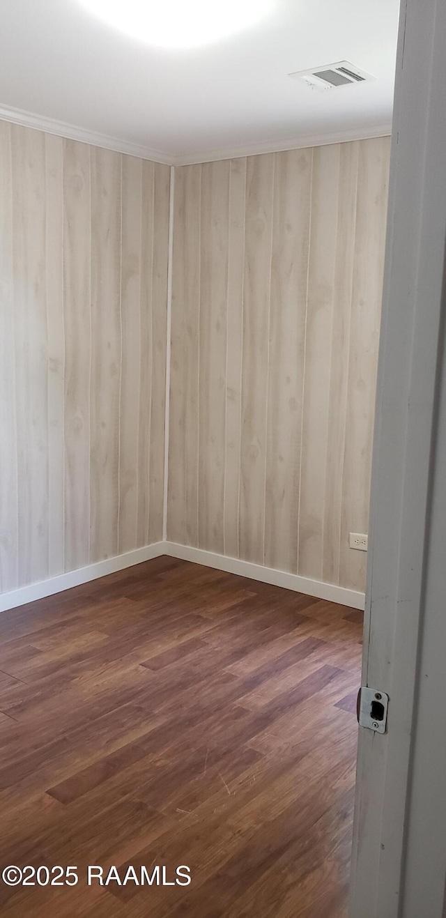 1814 E Lafayette St, Abbeville, LA 70510 - spare room featuring dark wood-type flooring and wooden walls