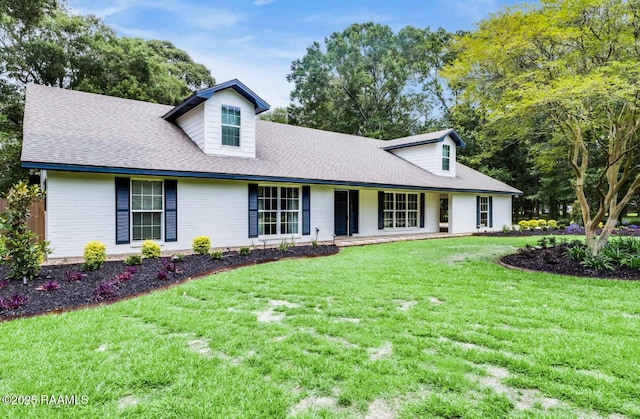 381 Rue Dauphine, Eunice, LA 70535 - new england style home featuring a front yard, roof with shingles, and a porch