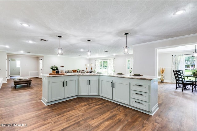 381 Rue Dauphine, Eunice, LA 70535 - kitchen featuring open floor plan, dark wood finished floors, recessed lighting, ornamental molding, and decorative light fixtures