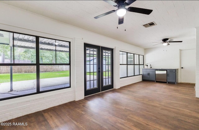 381 Rue Dauphine, Eunice, LA 70535 - unfurnished living room featuring wood finished floors, a ceiling fan, and french doors