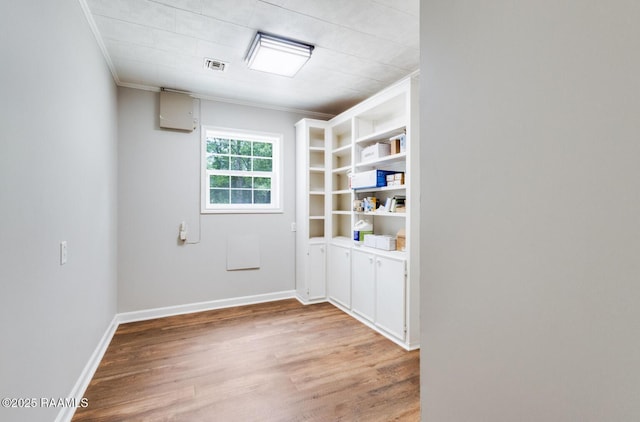 381 Rue Dauphine, Eunice, LA 70535 - unfurnished room with wood finished floors and crown molding