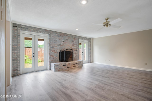 115 Breckenridge Loop, Lafayette, LA 70506 - unfurnished living room featuring french doors, crown molding, wood finished floors, a textured ceiling, and ceiling fan