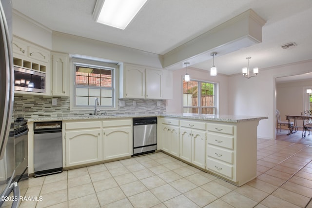 115 Breckenridge Loop, Lafayette, LA 70506 - kitchen featuring stainless steel appliances, a peninsula, backsplash, crown molding, and plenty of natural light