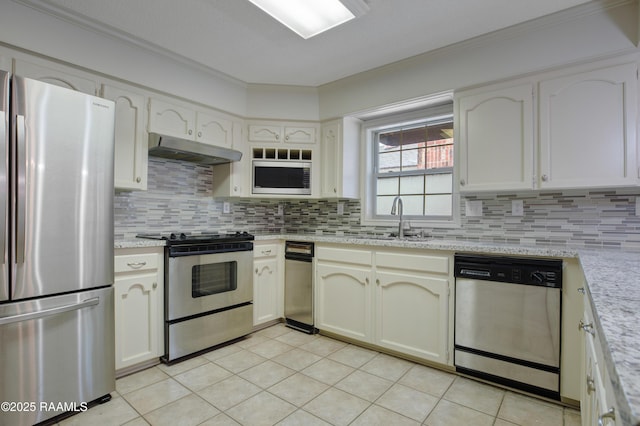 115 Breckenridge Loop, Lafayette, LA 70506 - kitchen featuring stainless steel appliances, under cabinet range hood, crown molding, backsplash, and light tile patterned floors