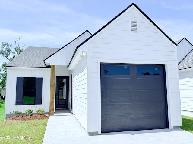 111 Twin Meadow Ln, Lafayette, LA 70508 - view of front of house featuring board and batten siding, a shingled roof, and an attached garage