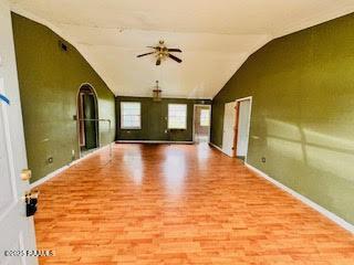 1627 Daniel St, Abbeville, LA 70510 - empty room featuring wood finished floors, vaulted ceiling, and a ceiling fan