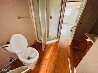1627 Daniel St, Abbeville, LA 70510 - full bathroom featuring a stall shower and wood finished floors