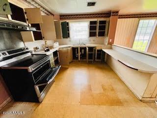 1627 Daniel St, Abbeville, LA 70510 - kitchen with stainless steel range with electric cooktop, light countertops, and extractor fan