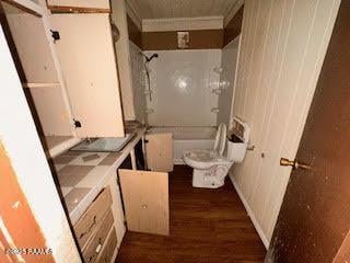 1627 Daniel St, Abbeville, LA 70510 - bathroom with wood finished floors, shower / washtub combination, vanity, and crown molding
