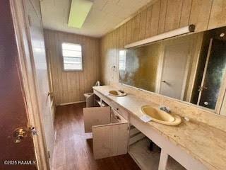 1627 Daniel St, Abbeville, LA 70510 - bathroom featuring wood finished floors, double vanity, a tub to relax in, and wooden walls