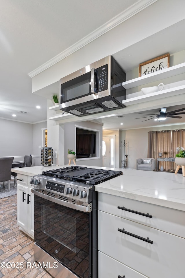 809 Dartez Dr, New Iberia, LA 70563 - kitchen featuring stainless steel appliances, crown molding, brick flooring, white cabinets, and light stone counters
