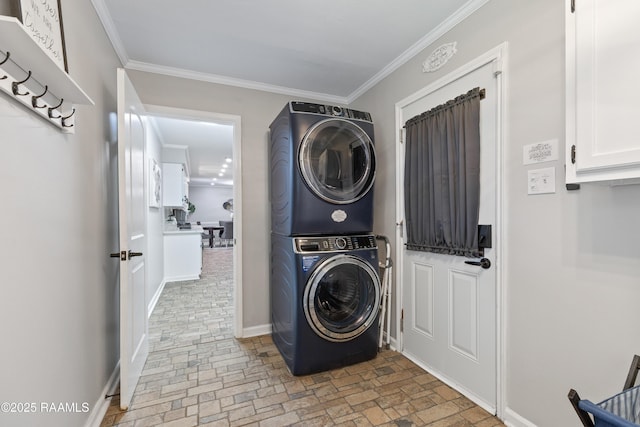 809 Dartez Dr, New Iberia, LA 70563 - laundry area featuring stacked washer and clothes dryer, brick patterned floors, and ornamental molding