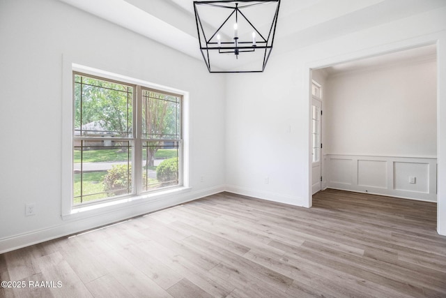 806 Beaujolais Pkwy, Lafayette, LA 70503 - unfurnished dining area featuring healthy amount of natural light, a chandelier, wood finished floors, and wainscoting
