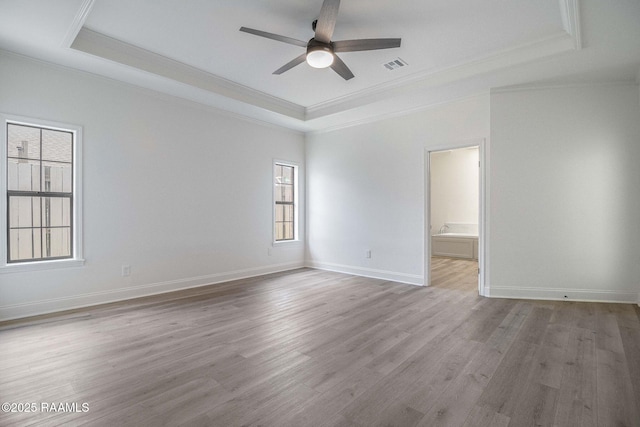 806 Beaujolais Pkwy, Lafayette, LA 70503 - spare room with a raised ceiling, ornamental molding, ceiling fan, and wood finished floors