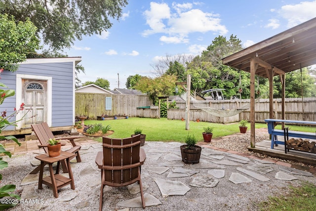 234 Ridgewood St, Lafayette, LA 70506 - fenced backyard with a patio area, a storage shed, and a fire pit