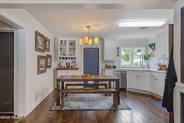 234 Ridgewood St, Lafayette, LA 70506 - dining room with a chandelier, ornamental molding, and dark wood-style floors