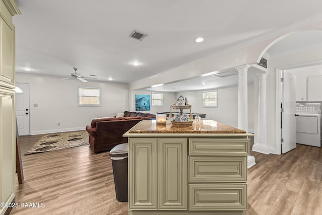 1329-B Grand Anse Hwy, Breaux Bridge, LA 70517 - kitchen featuring washer / clothes dryer, open floor plan, a ceiling fan, light wood-style floors, and a kitchen island
