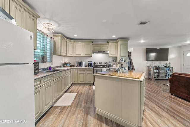 1329-B Grand Anse Hwy, Breaux Bridge, LA 70517 - kitchen featuring freestanding refrigerator, cream cabinetry, light wood-style floors, open floor plan, and recessed lighting
