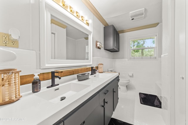 1329-B Grand Anse Hwy, Breaux Bridge, LA 70517 - bathroom with double vanity, tile walls, and a wainscoted wall