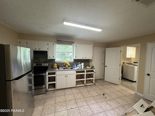 7226 Meadowview Ave, Baton Rouge, LA 70810 - kitchen featuring appliances with stainless steel finishes, washer / dryer, a textured ceiling, white cabinetry, and backsplash