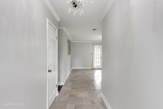 921 Bellevue Plantation Rd, Lafayette, LA 70503 - hallway with stone tile floors, crown molding, and a chandelier