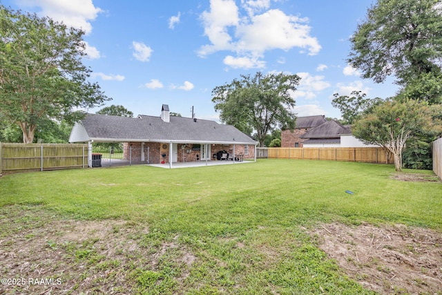 921 Bellevue Plantation Rd, Lafayette, LA 70503 - rear view of house featuring a patio, a fenced backyard, a chimney, and brick siding