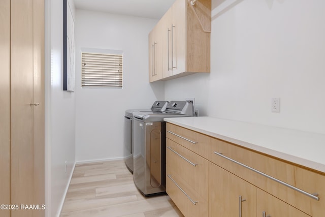 3703 Daspit Rd, New Iberia, LA 70563 - laundry room featuring cabinet space, washer and dryer, and light wood-type flooring