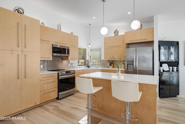 3703 Daspit Rd, New Iberia, LA 70563 - kitchen featuring appliances with stainless steel finishes, light brown cabinets, light countertops, and recessed lighting