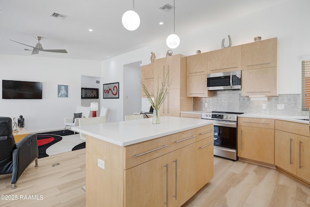 3703 Daspit Rd, New Iberia, LA 70563 - kitchen with appliances with stainless steel finishes, light brown cabinets, open floor plan, light wood-style floors, and recessed lighting