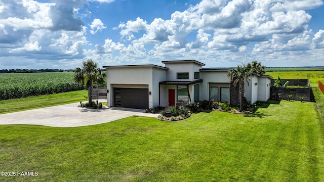 3703 Daspit Rd, New Iberia, LA 70563 - contemporary house with stucco siding, agricultural plots, a view of countryside, concrete driveway, and an attached garage