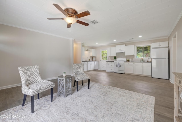 109 Guadalajara St, New Iberia, LA 70563 - living area with ornamental molding, wood finished floors, a ceiling fan, and recessed lighting