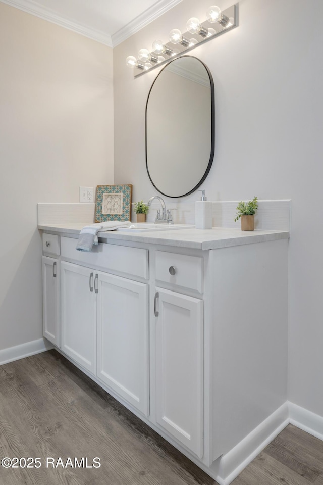109 Guadalajara St, New Iberia, LA 70563 - bathroom featuring ornamental molding, vanity, and wood finished floors