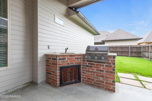 106 Whitewater Dr, Broussard, LA 70518 - fenced backyard featuring a patio and an outdoor kitchen