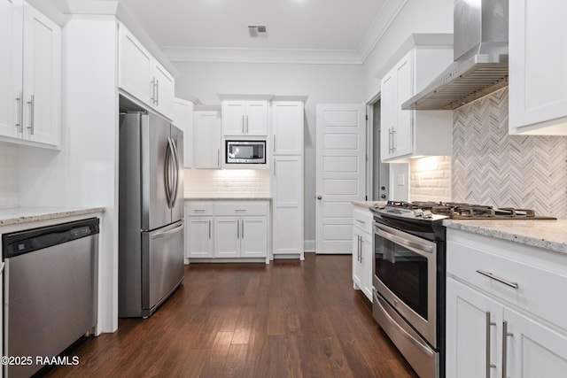 106 Whitewater Dr, Broussard, LA 70518 - kitchen with appliances with stainless steel finishes, wall chimney exhaust hood, tasteful backsplash, crown molding, and dark wood-style flooring