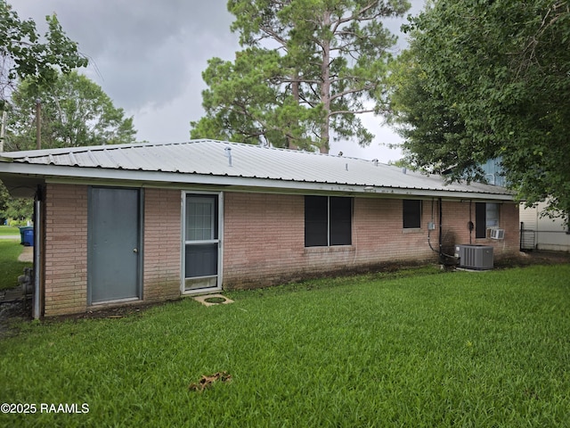 119 Romero St, Youngsville, LA 70592 - back of property with a yard, brick siding, and a metal roof