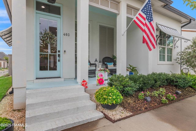 403 Catalina Ln, Youngsville, LA 70592 - property entrance with a porch and stucco siding