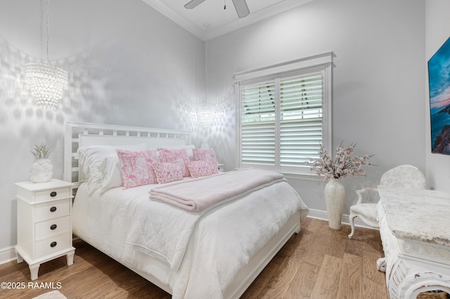 403 Catalina Ln, Youngsville, LA 70592 - bedroom with wood finished floors, ornamental molding, a chandelier, and ceiling fan